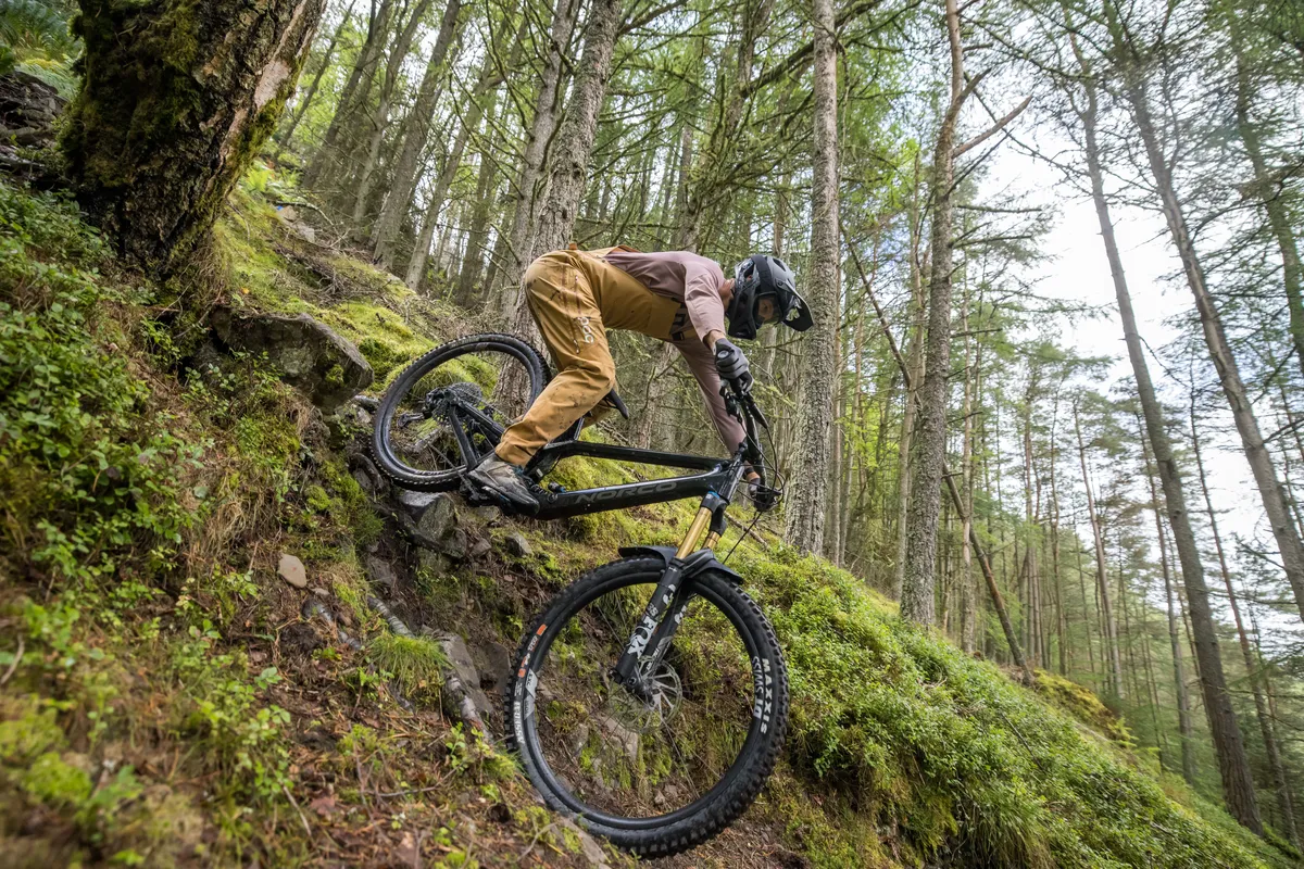 Norco Range C1 high pivot trail mountain bike ridden by male mountain bike tester Alex Evans on a trail called Too Hard For EWS in Scotland's Tweed Valley in the UK.
