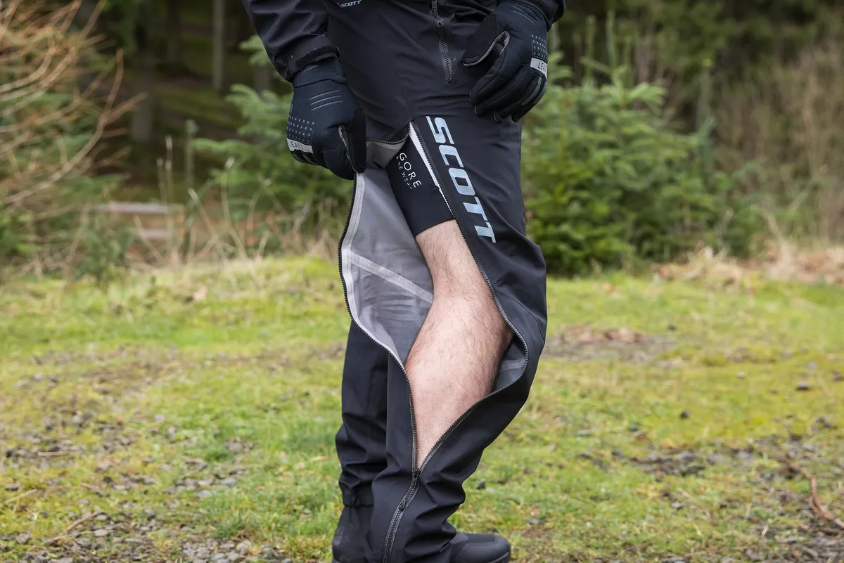 Scott Trail Storm WP Men's One Piece waterproof mountain biking suit worn by male mountain biker.