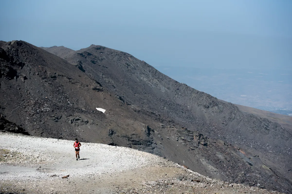 Runner on Pico Veleta gravel road in Spain's Sierra Nevada mountains