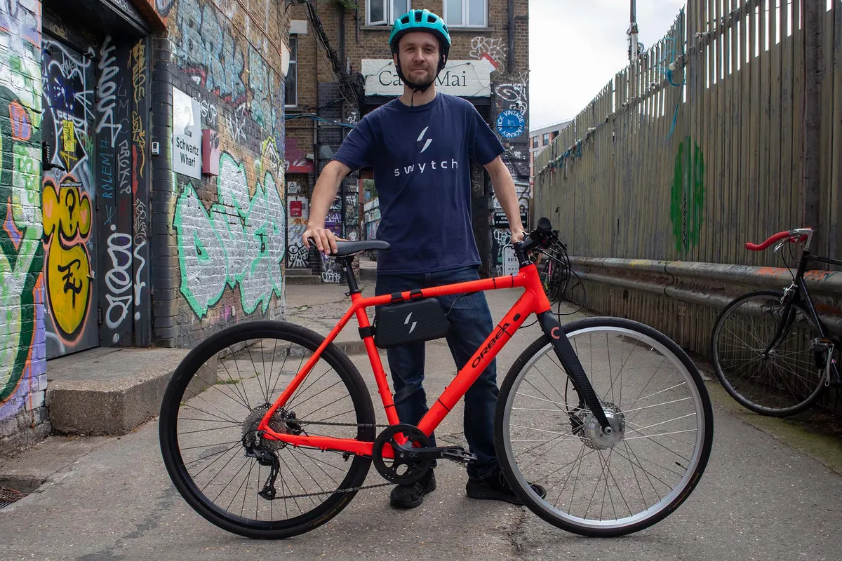 Swytch Technology CEO Oliver Montague posing with bike fitted with Swytch Go kit.
