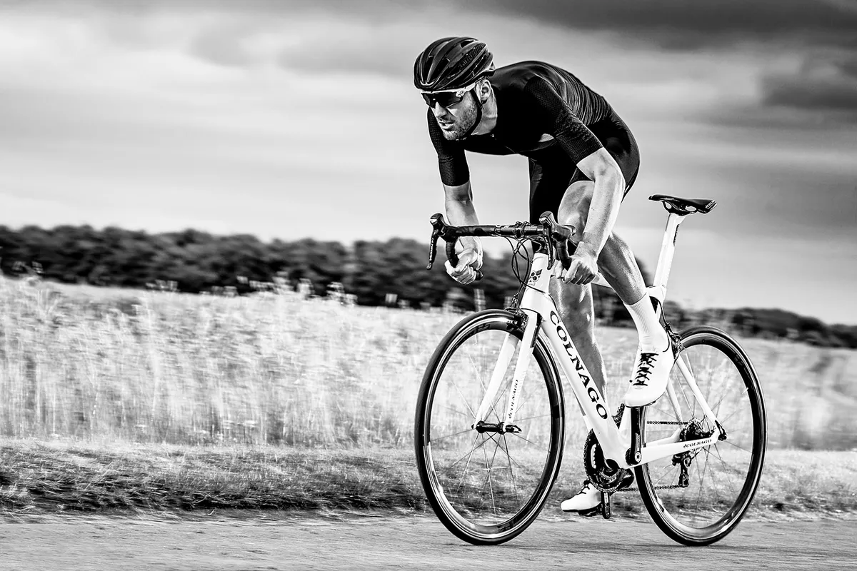 Black and white image of male road cyclist