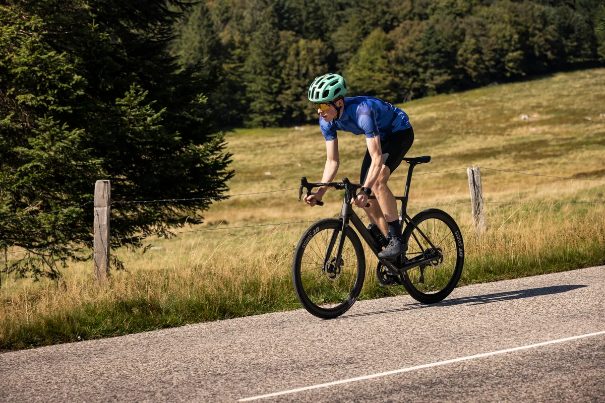 Jack Evans climbing out of saddle of Focus Izalco Max 9.9