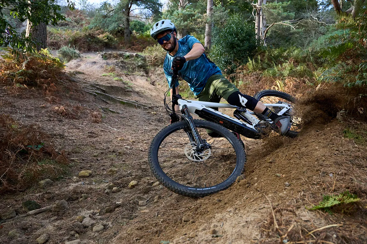 Vitus E-Mythique LT VRX electric montain bike ridden by male mountain biker in the Surrey Hills, United Kingdom.