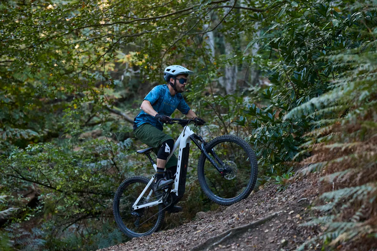 Vitus E-Mythique LT VRX electric montain bike ridden by male mountain biker in the Surrey Hills, United Kingdom.