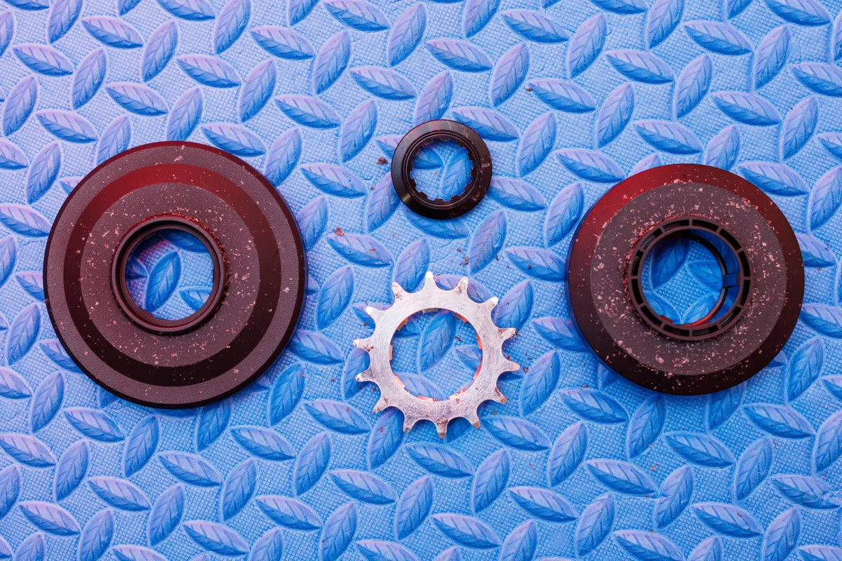 Zwift Cog in pieces photographed on blue foam mat.
