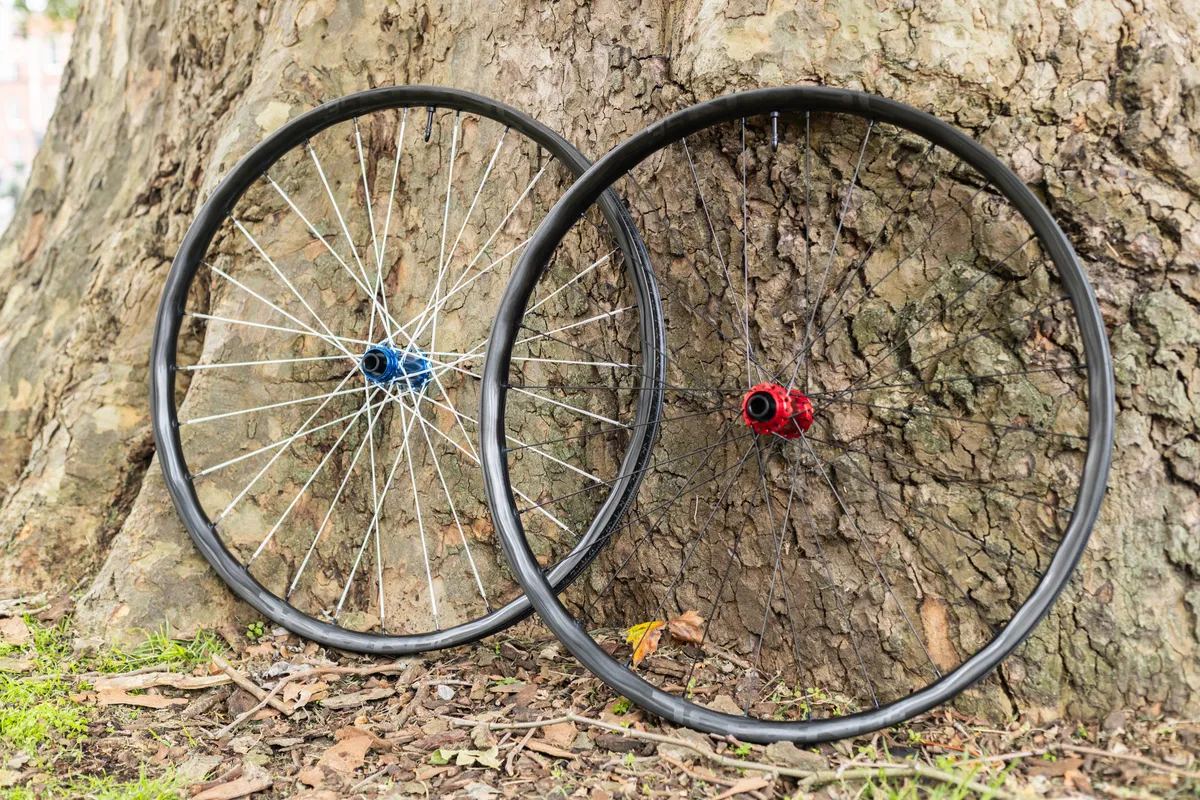 NOBL wheels next to one another with fabric spokes (left) and steel spokes (right).