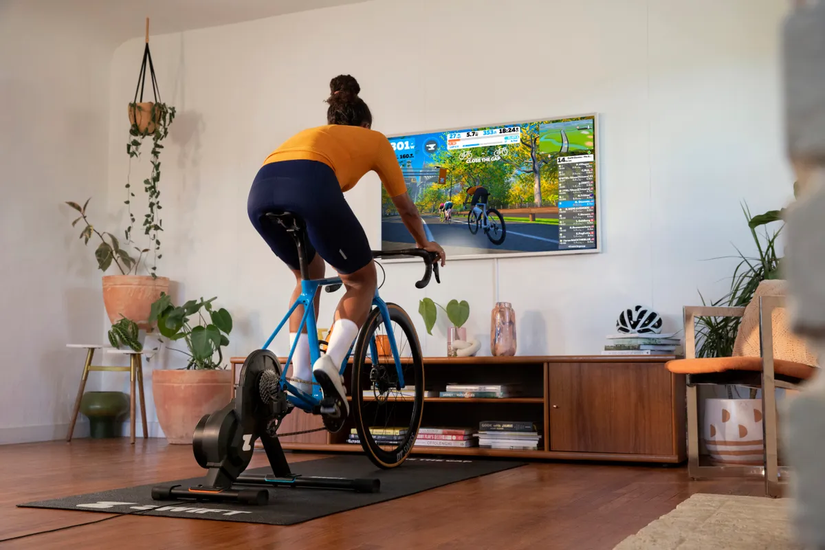 Woman riding Zwift in her living room
