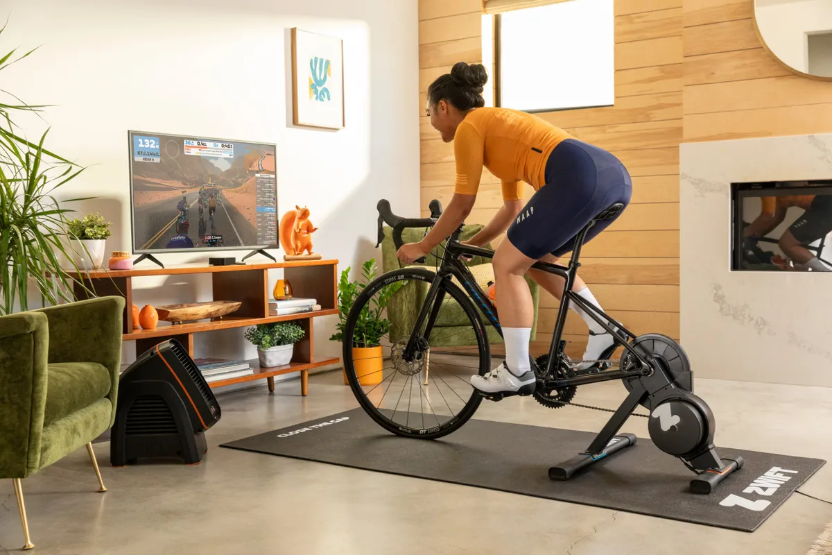 Woman riding Zwift Hub in living room
