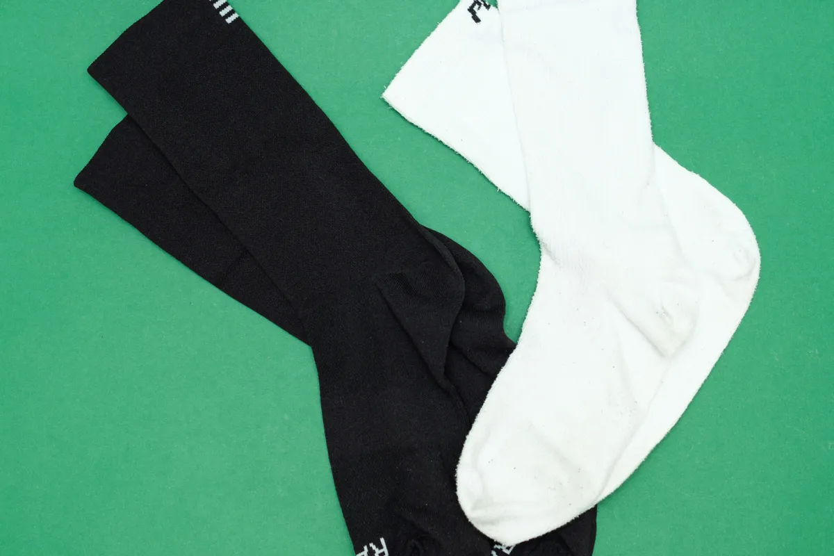 Black and white cyclin socks on a green background
