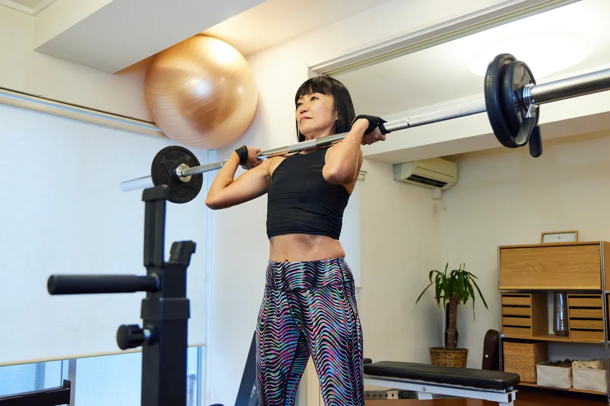 Female athlete lifting a barbell at the gym