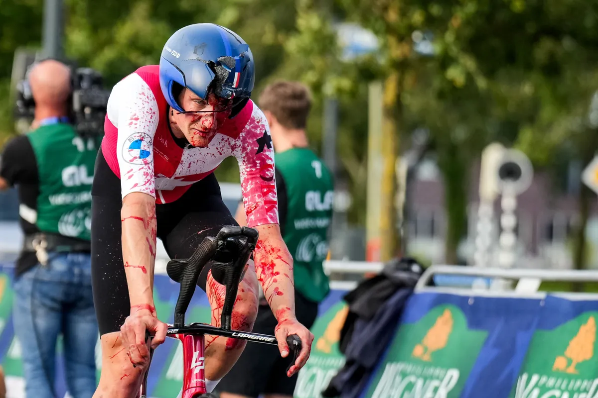 Stefan Kung of Switzerland finishes with a broken helmet and covered with blood after competing in the Men's Individual Time Trial of the 2023 UEC Road Cycling European Championships