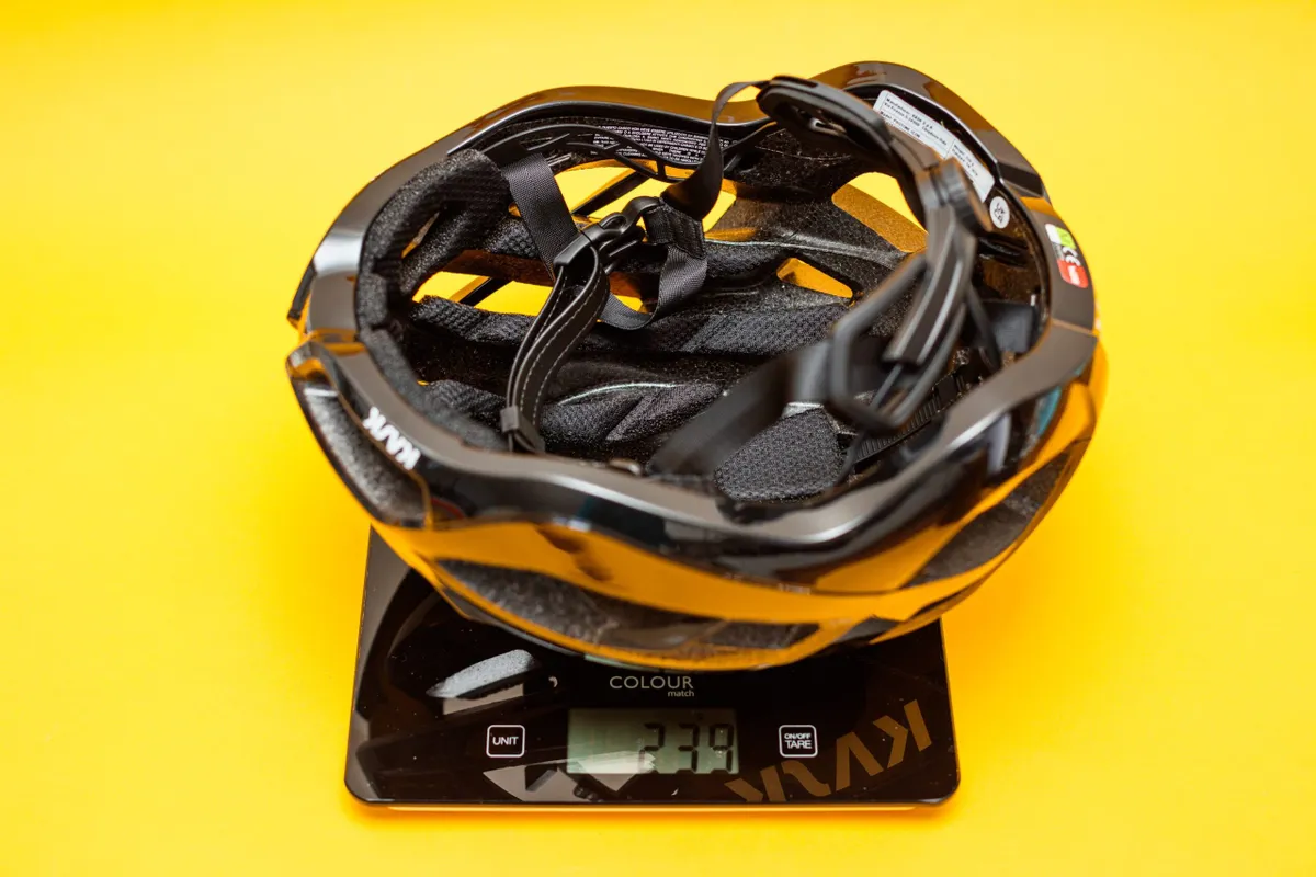 Kask Protone Icon Black Medium on scales showing weight of 239g.