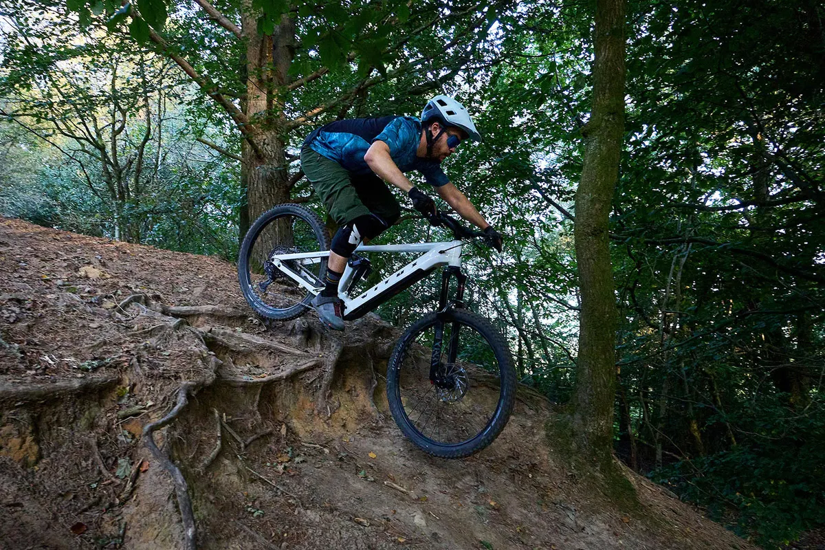 Mal rider in blue top riding the Vitus E Mythique LT 297 VRX full suspension mountain ebike