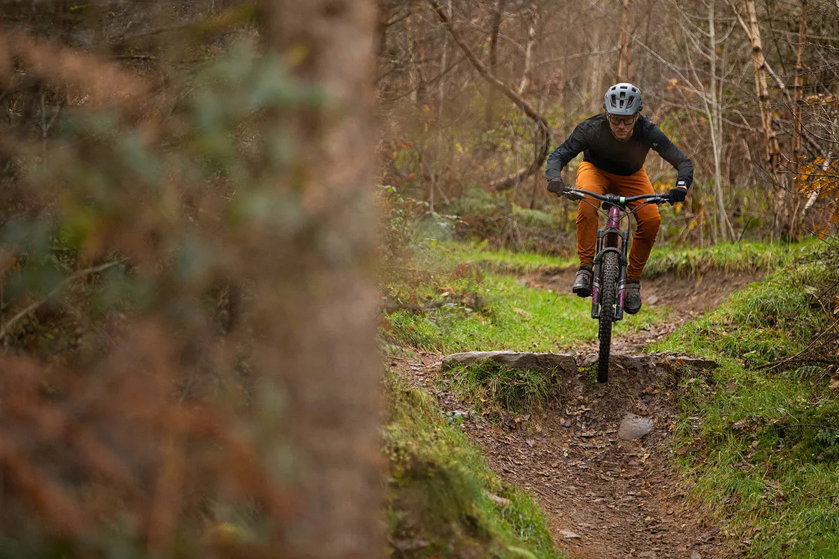 Male rider in a black top riding the Transition Smuggler Trail Mountain Bike
