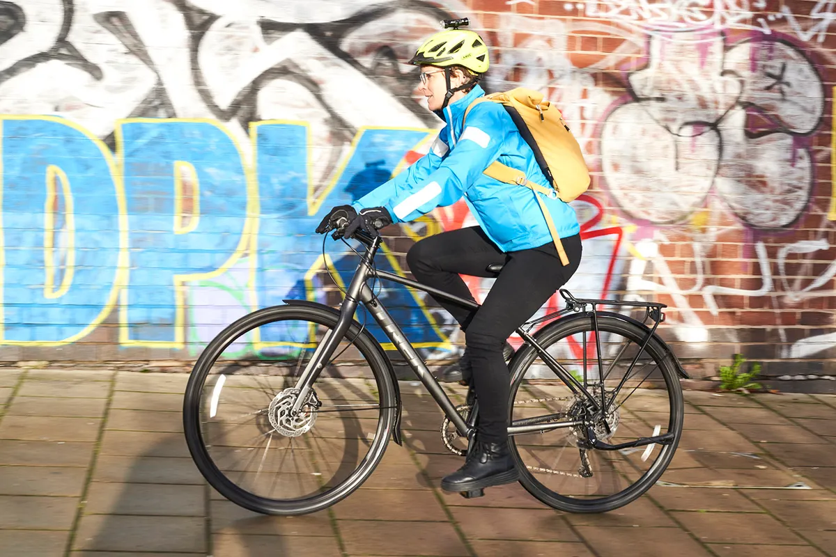Cyclist in blue top riding the Trek FX 3 Disc Equipped commuter bike