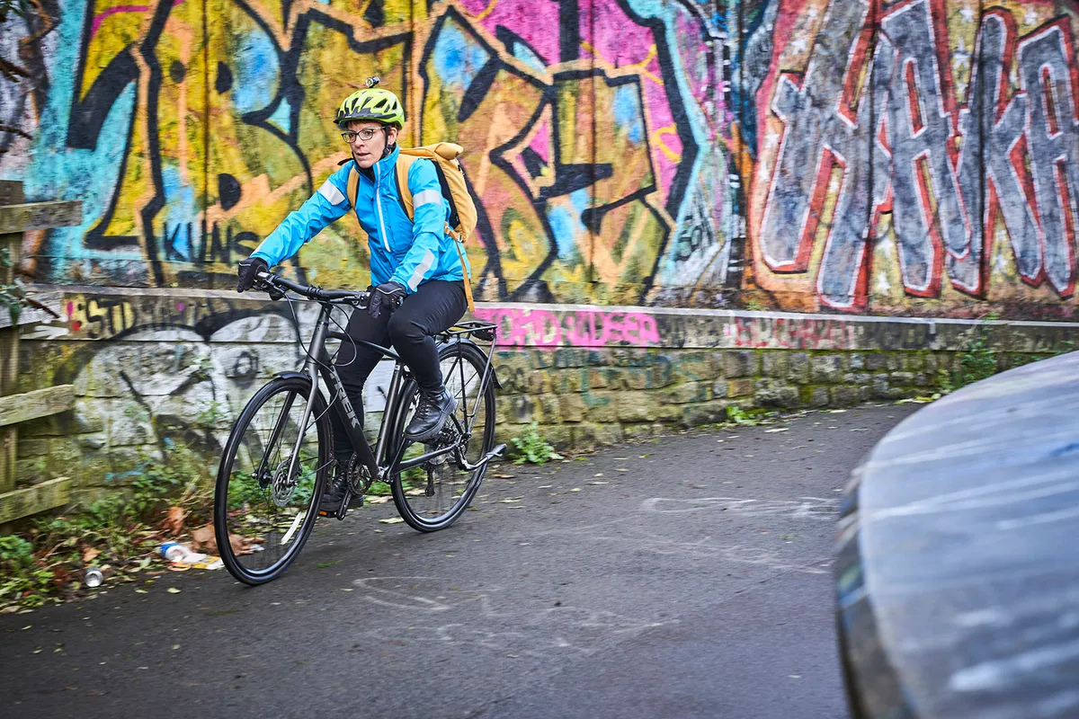 Cyclist in blue top riding the Trek FX 3 Disc Equipped commuter bike