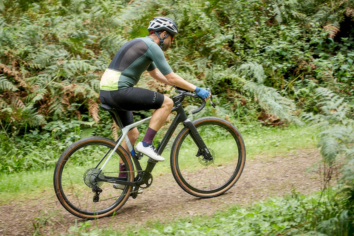 Male cyclist in green top riding the Cipollini Ago gravel bike
