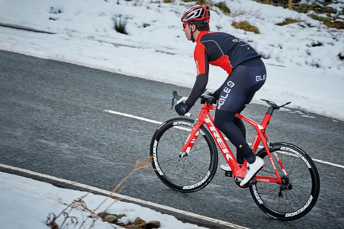Male cyclist riding in wintery conditions