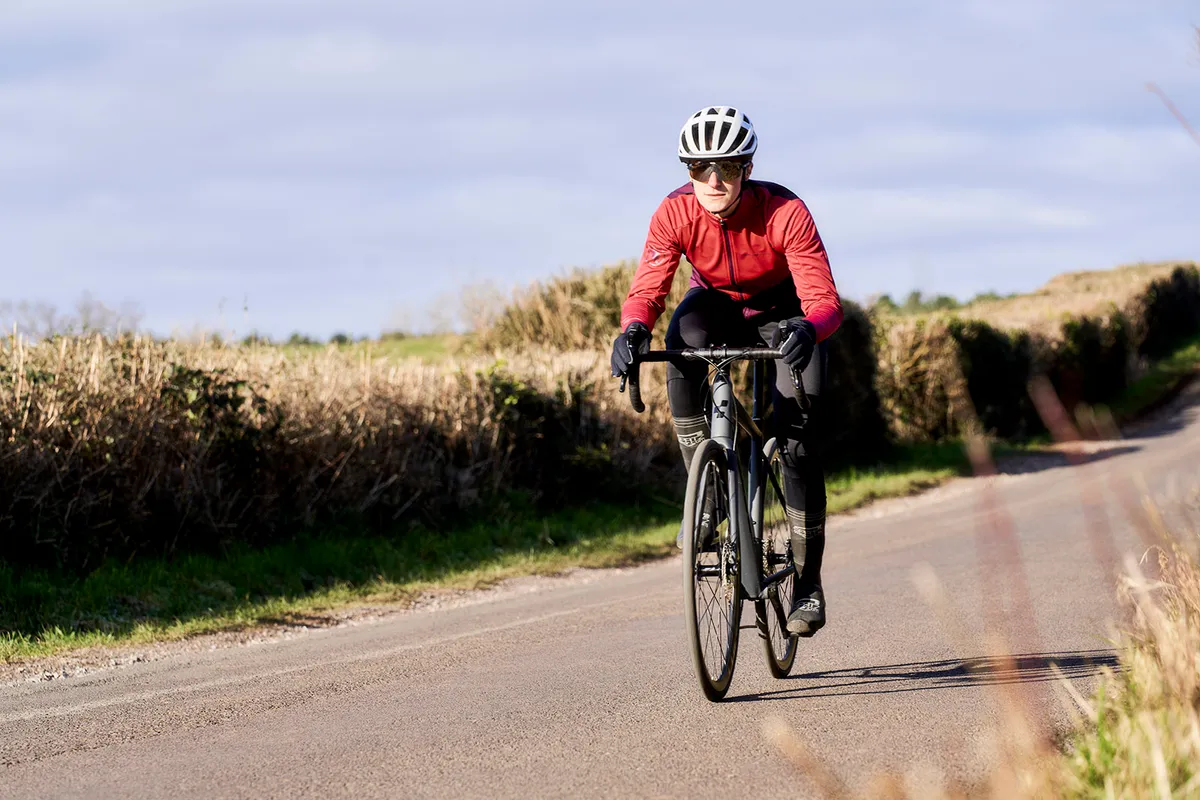 Male cyclist in red top riding the Cube Attain SLX road bike