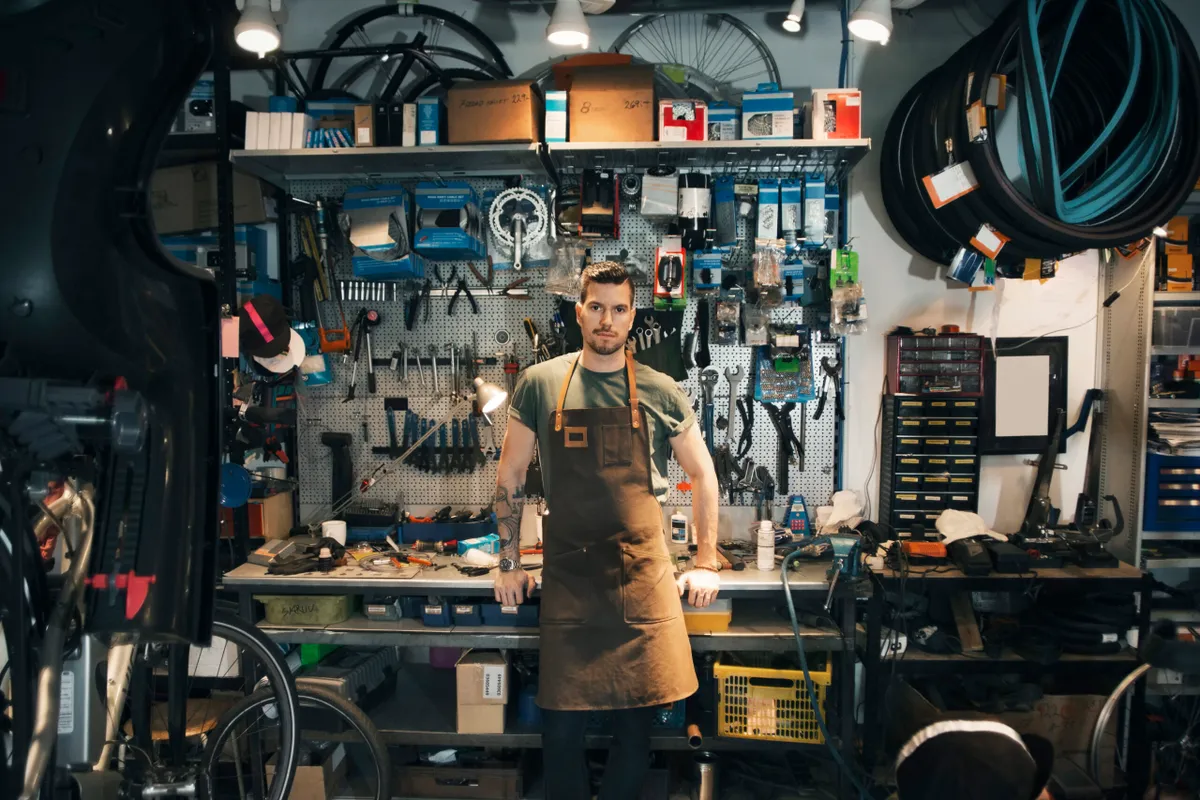 A mechanic standing in front of a workshop