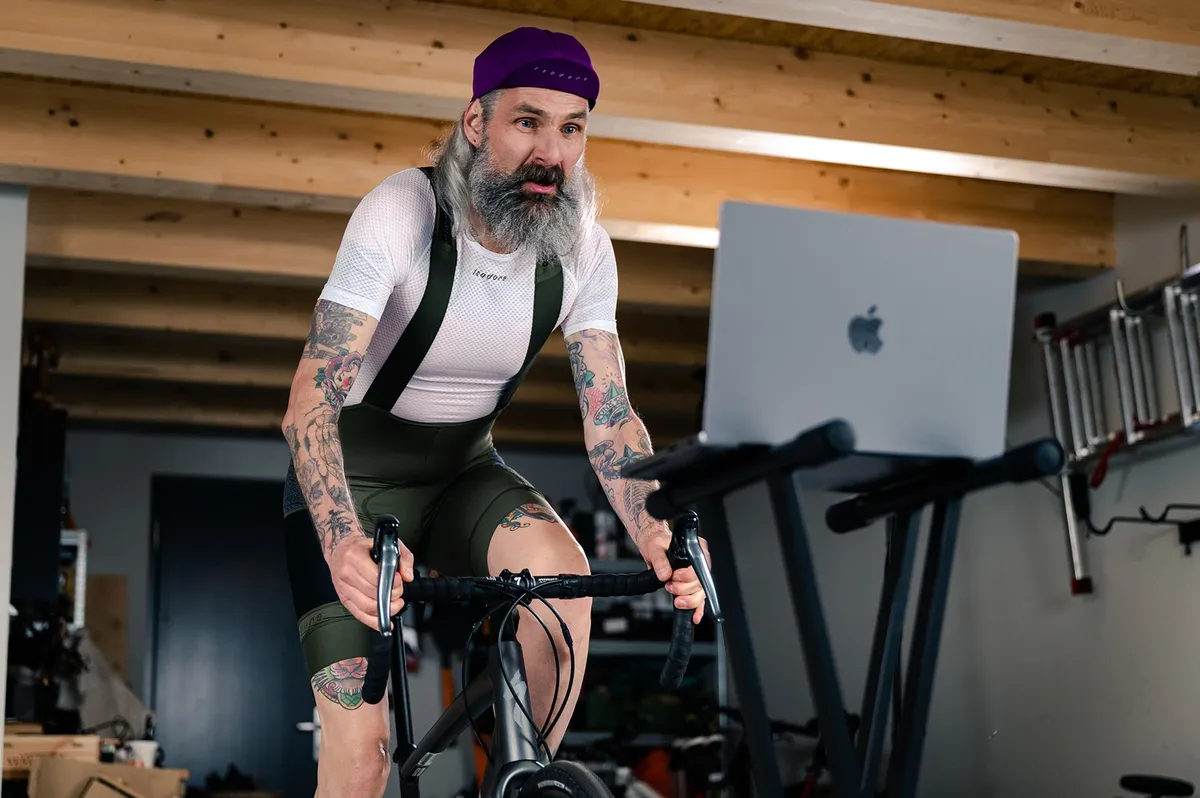 Man riding out of the saddle on Rouvy indoor cycling app