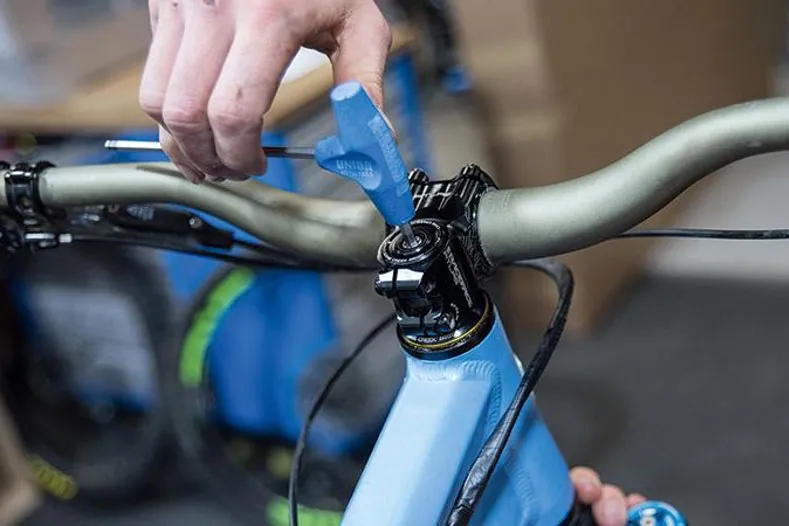 Cyclist working on the headset of a mountain bike