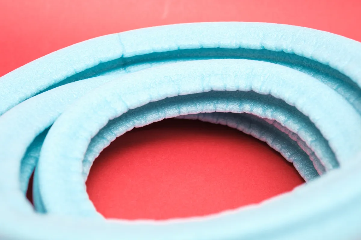 Close-up of Tubolight EVO gravel tyre insert on red background
