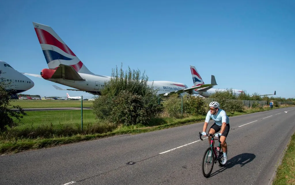 Kemble, Gloucestershire, England, British Airways 747 aircraft lines up for disassembly at Cotswold Airport due to Covid epidemic. Cyclists on an ride to view. (Photo by: Photographer name/Education Images/Universal Images Group via Getty Images)