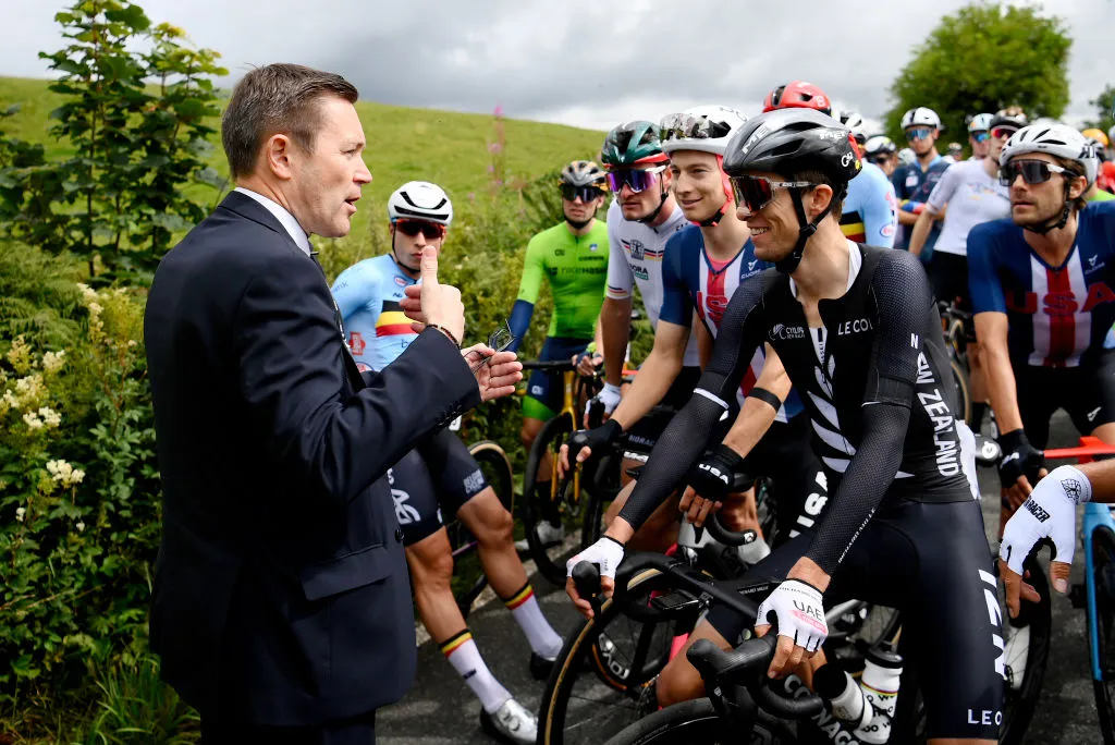 UCI president David Lappartient speaking to riders while protestors briefly disrupted the men's elite road race at the 2023 cycling world championships.
