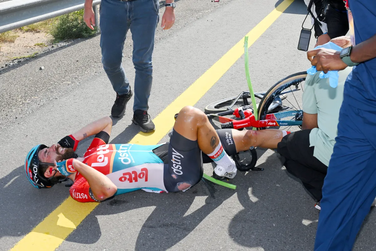 Thomas De Gendt lying in the road after crashing during stage 05 of the 2024 UAE Tour
