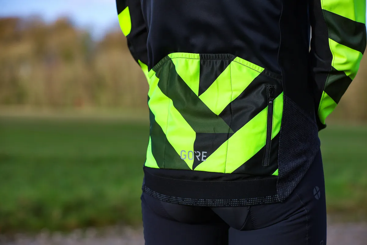 Rear of Gore cycling jacket showing yellow stripes on pocket.