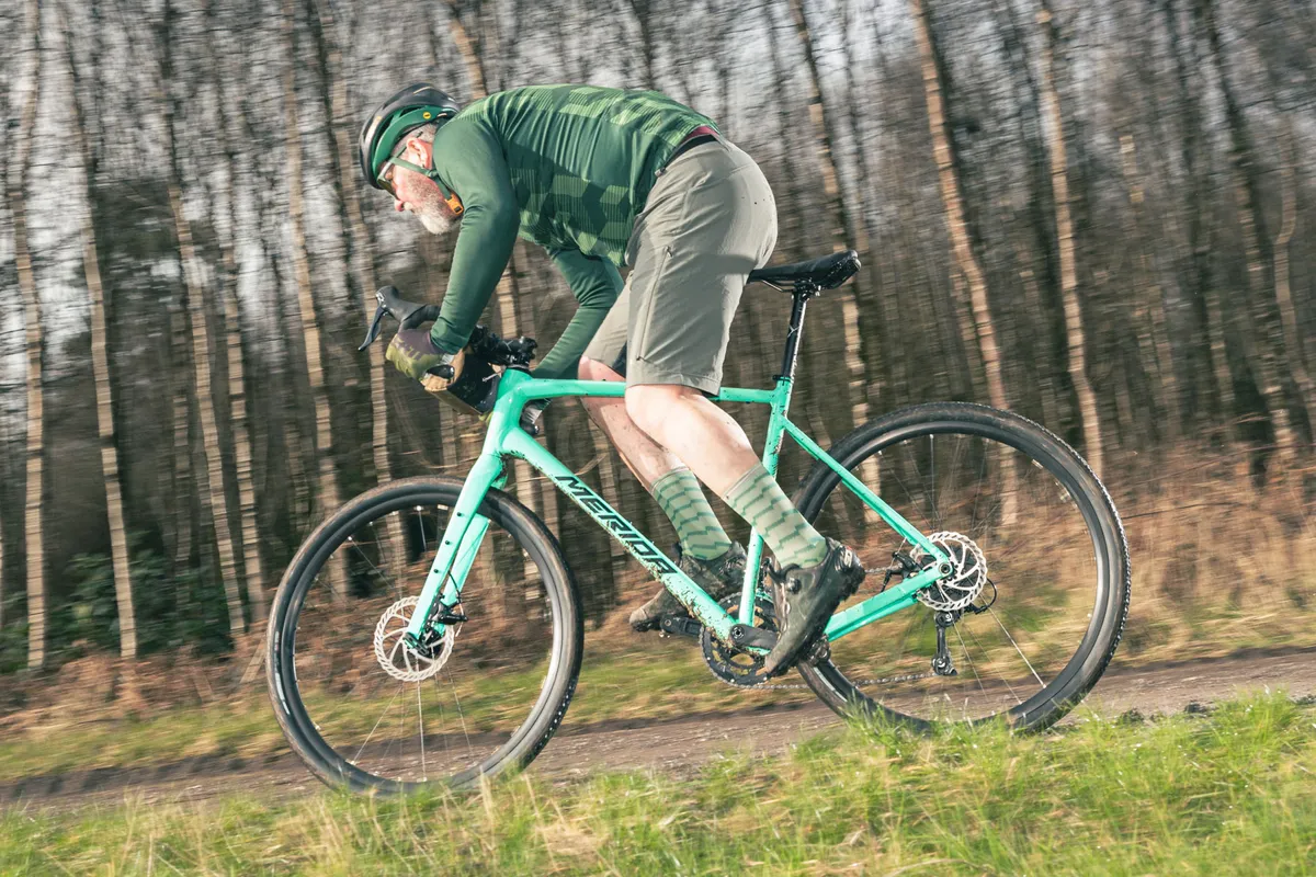 Male cyclist in green top rider the Merida Silex 200 gravel bike