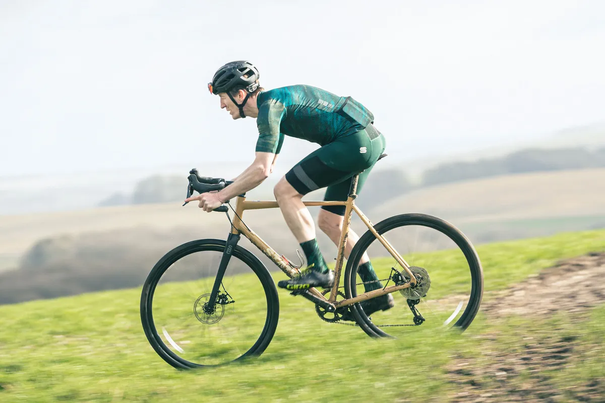 Male cyclist in green top riding the State 6061 All-Road Black Label gravel bike