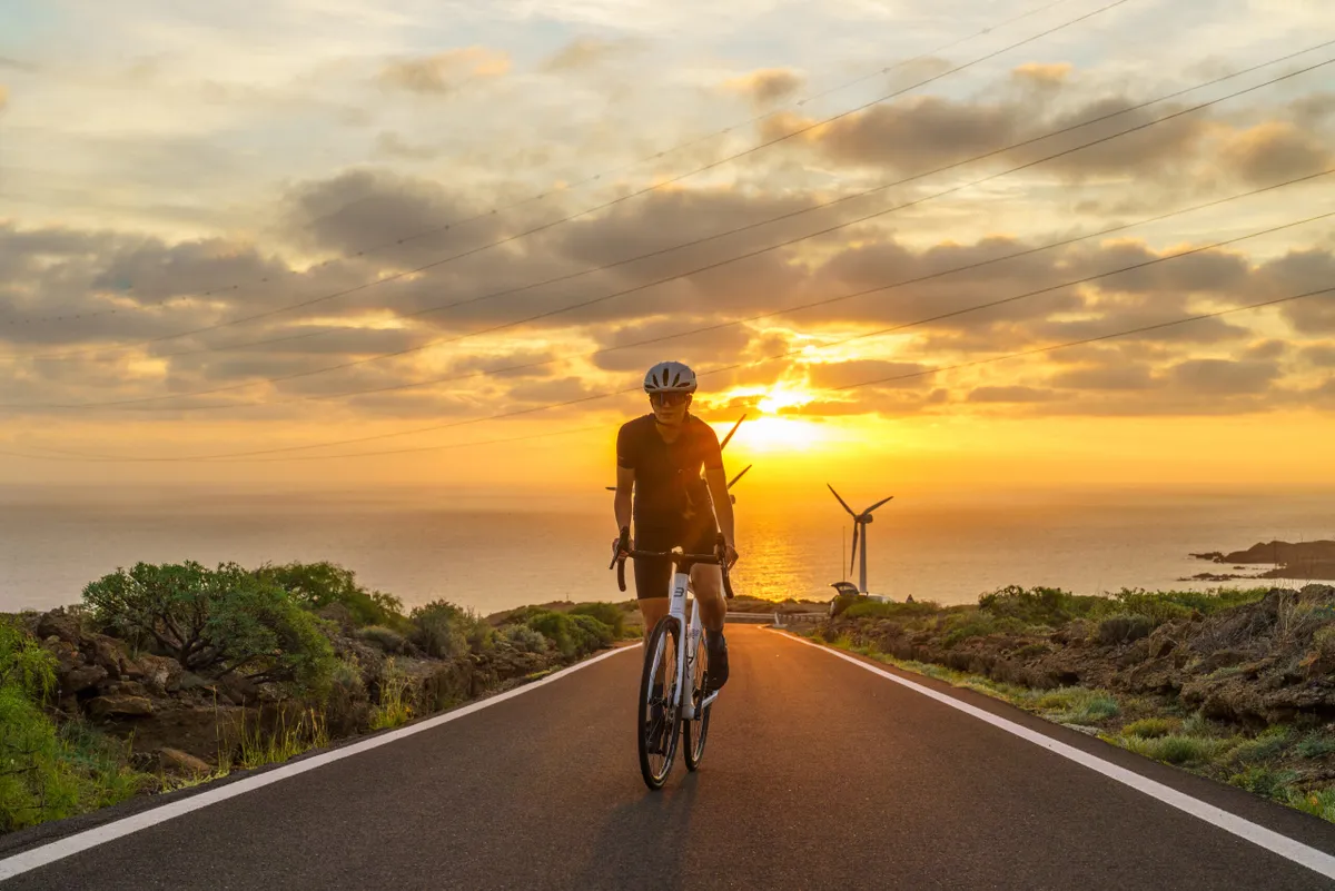 Female cyclist riding Basso Venta R in front of seaside sunset