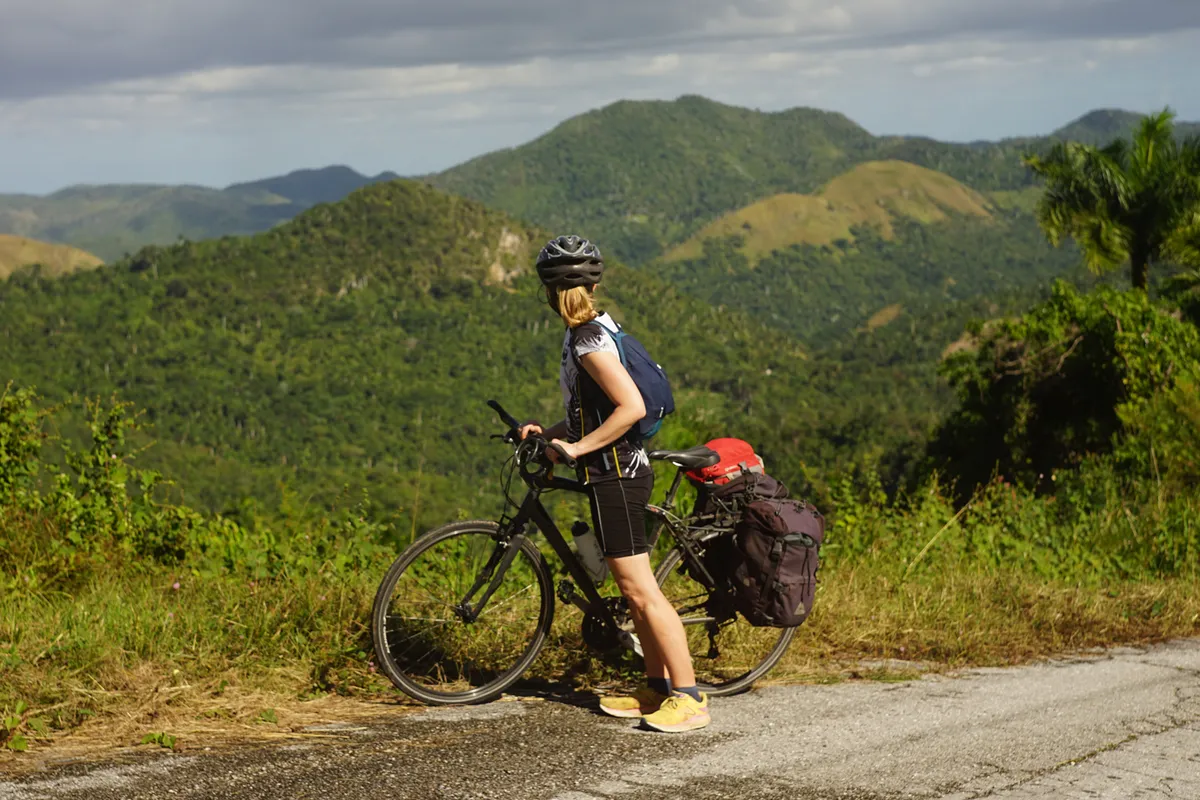 Woman on bike overlooking Cuban landscape.