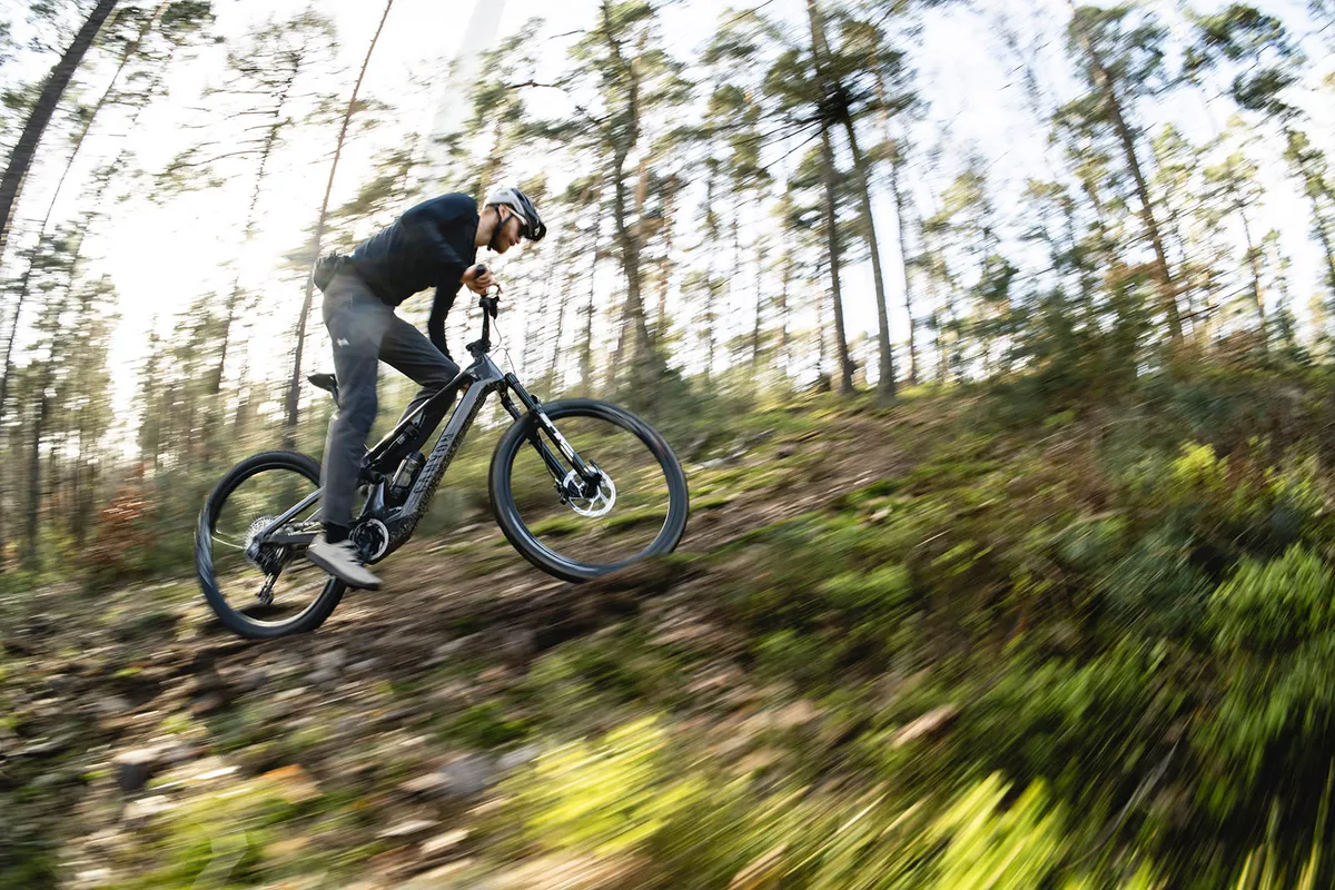 Male rider riding the Neuron:ONfly full sus eMTB up hill