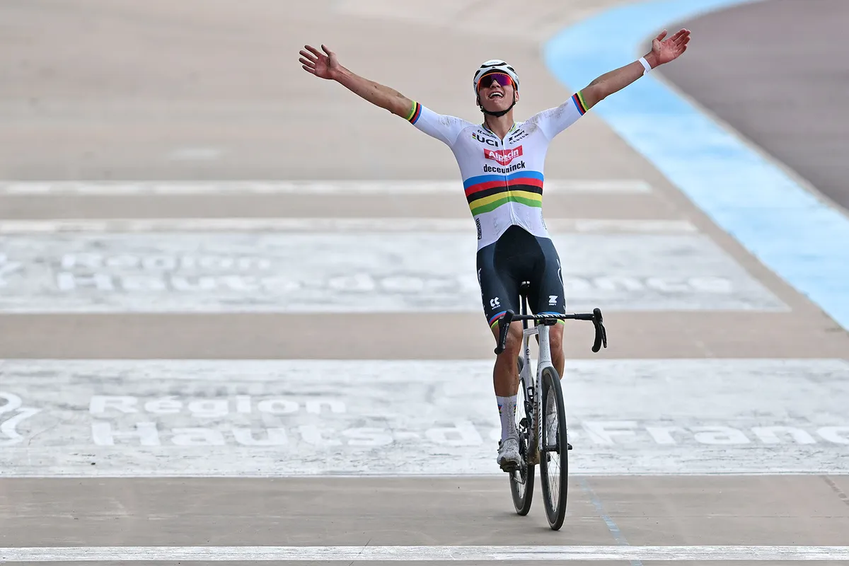 Mathieu van der Poel throwing arms in the air as he wins the 2024 Paris-Roubaix.