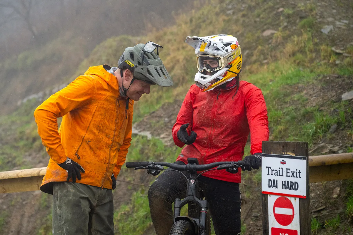 Male and female mountain bikers talking