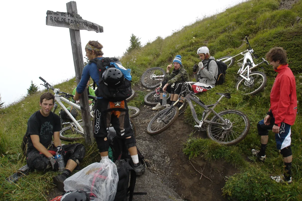 A group of mountain bikes at the top of a French Alp on a wid range of different mountain bikes.
