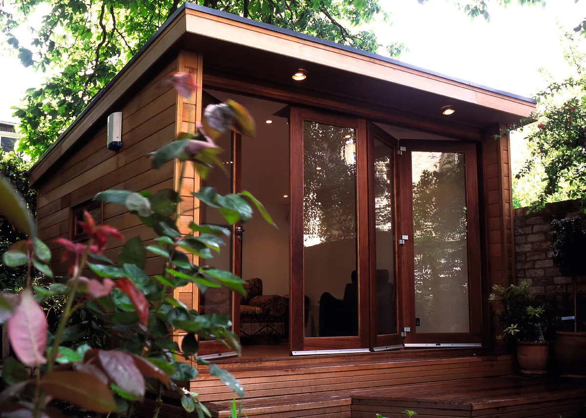 A garden office which is a modern style wooden shed with glass concertina doors