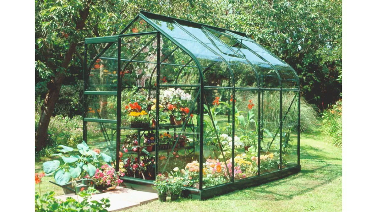 Halls Highgrove Greenhouse and Base in a garden