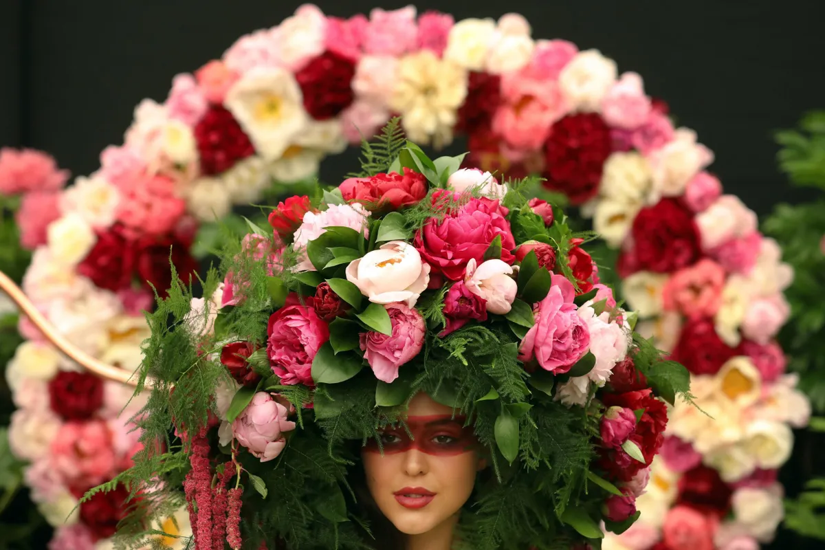 A model poses in a floral headress of peonys by Kate Halfpenny on the Primrose Hall exhibit at the RHS Chelsea Flower show in London Monday May 22, 2017..RHS / Luke MacGregor
