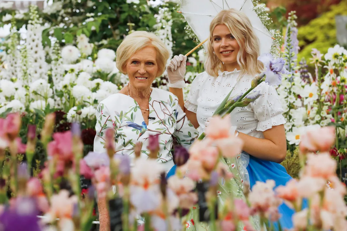 Celebrity Chef Mary Berry, poses with model Colombine Leathart on the Cayeaux Iris exhibition during press day at the RHS Chelsea Flower Show 2018 in London Monday, May 21, 2018..RHS / Luke MacGregor