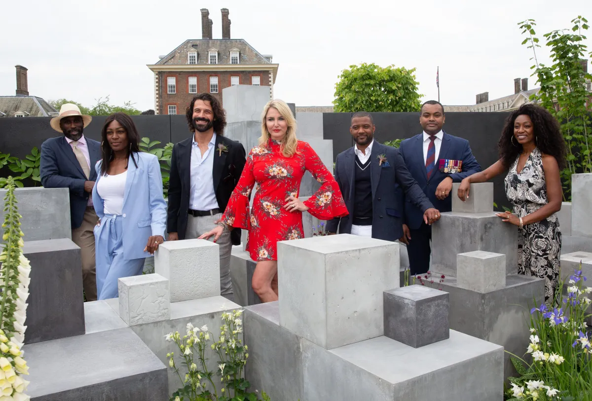 Guests including Sol Campbell, far left, Nancy Sorrell, centre, and Beverly Knight, far right, pose for photographs in the Skin Deep Garden during press day at the the RHS Chelsea Flower Show 2018 in London, May 21, 2018. RHS/Suzanne Plunkett