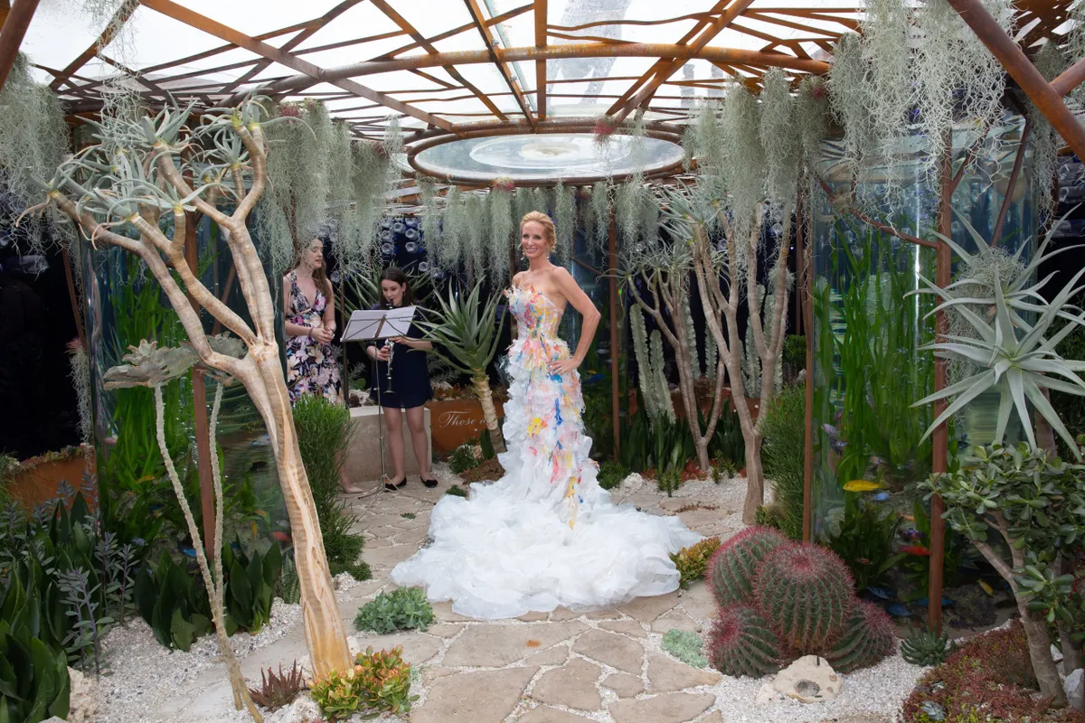 World champion free-diver Tanya Streeter laughs during a photo call at the Pearlfisher Garden during press day at the the RHS Chelsea Flower Show 2018 in London, May 21, 2018. Streeter's gown is made from plastic found on Brighton Beach and was made by students from the University of Brighton to highlight the threat of plastic waste to the oceans. RHS/Suzanne Plunkett