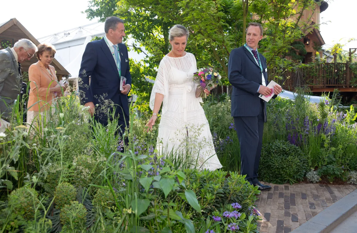 2018: Sophie the Countess of Wessex is escorted by RHS Council member Chris Blundel , left, and RHS Director of Technology and Editorial Matt Rooke in the RHS Feel Good Garden