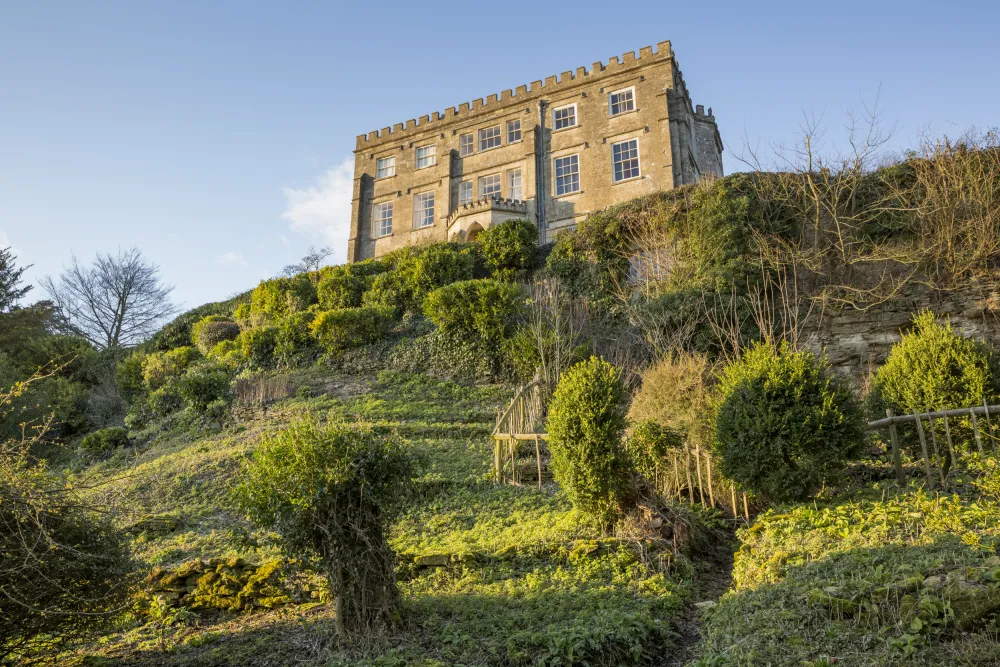 The south front of Newark Park, Gloucestershire. Perched high on a spur of the Cotswolds, overlooking the valley of the river Severn. Originally an Elizabethan hunting lodge built by Sir Nicholas Poyntz in c.1550, alterations were made in the 1790s attributed to James Wyatt.
