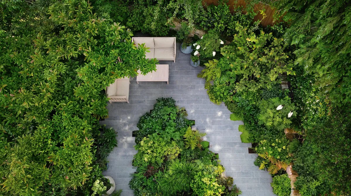 By placing the furniture at the rear of the space, Stefano gave his clients a new perspective on the garden. A large Cornus kousa var. chinensis behind the sofa provides privacy and a sense of enclosure, complemented by the branches of an overhanging magnolia.