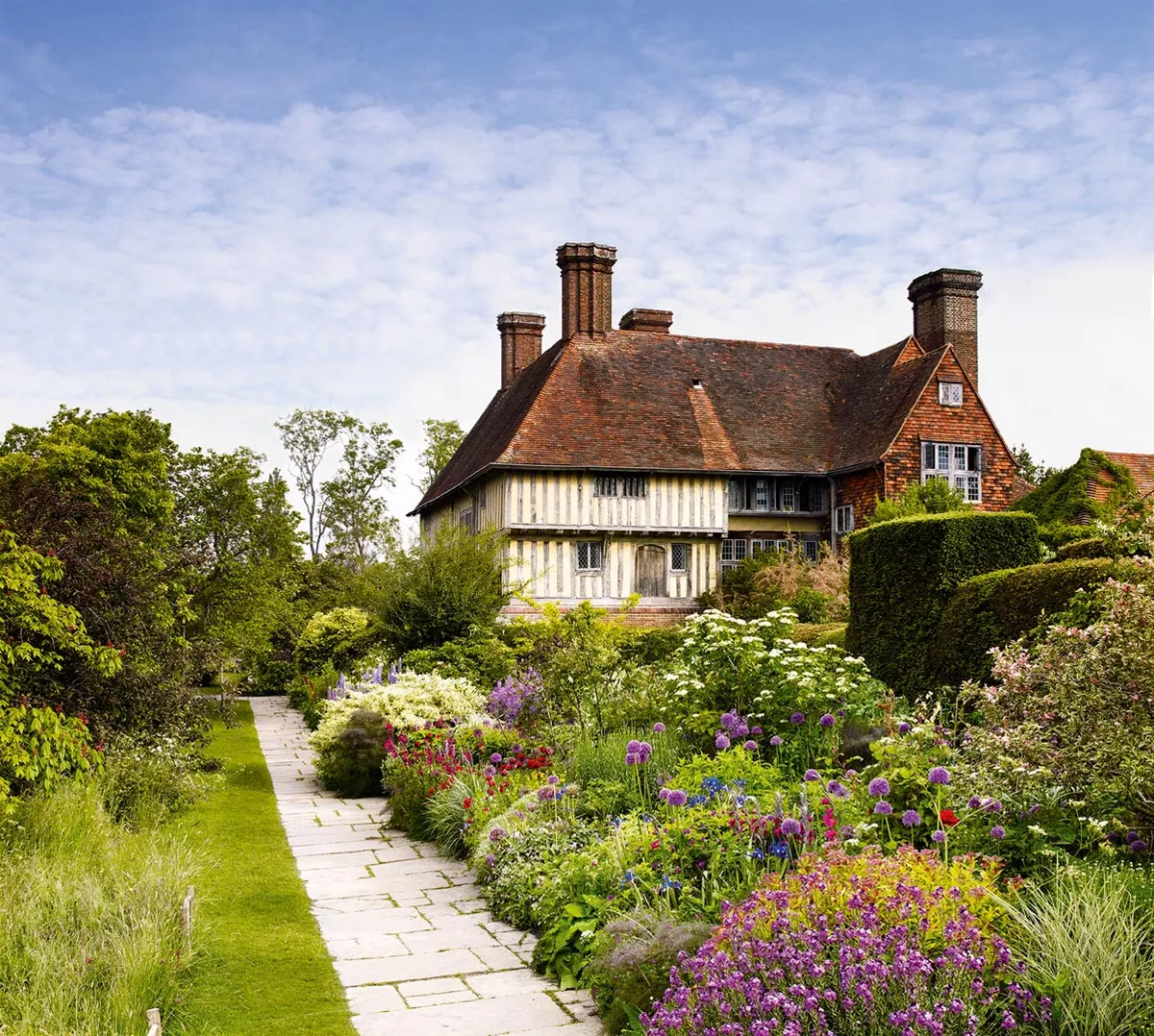 Great Dixter’s famous mixed Long Border is deeply layered with shrubs and perennials, and dotted with bulbs and annuals to provide a long season of colour.