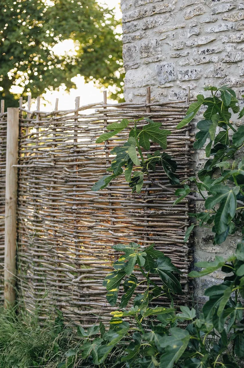 Hazel hurdles are a sympathetic way of enclosing and protecting the Vegetable Garden in the gap between the Farrowing House and the long, low Calf House.